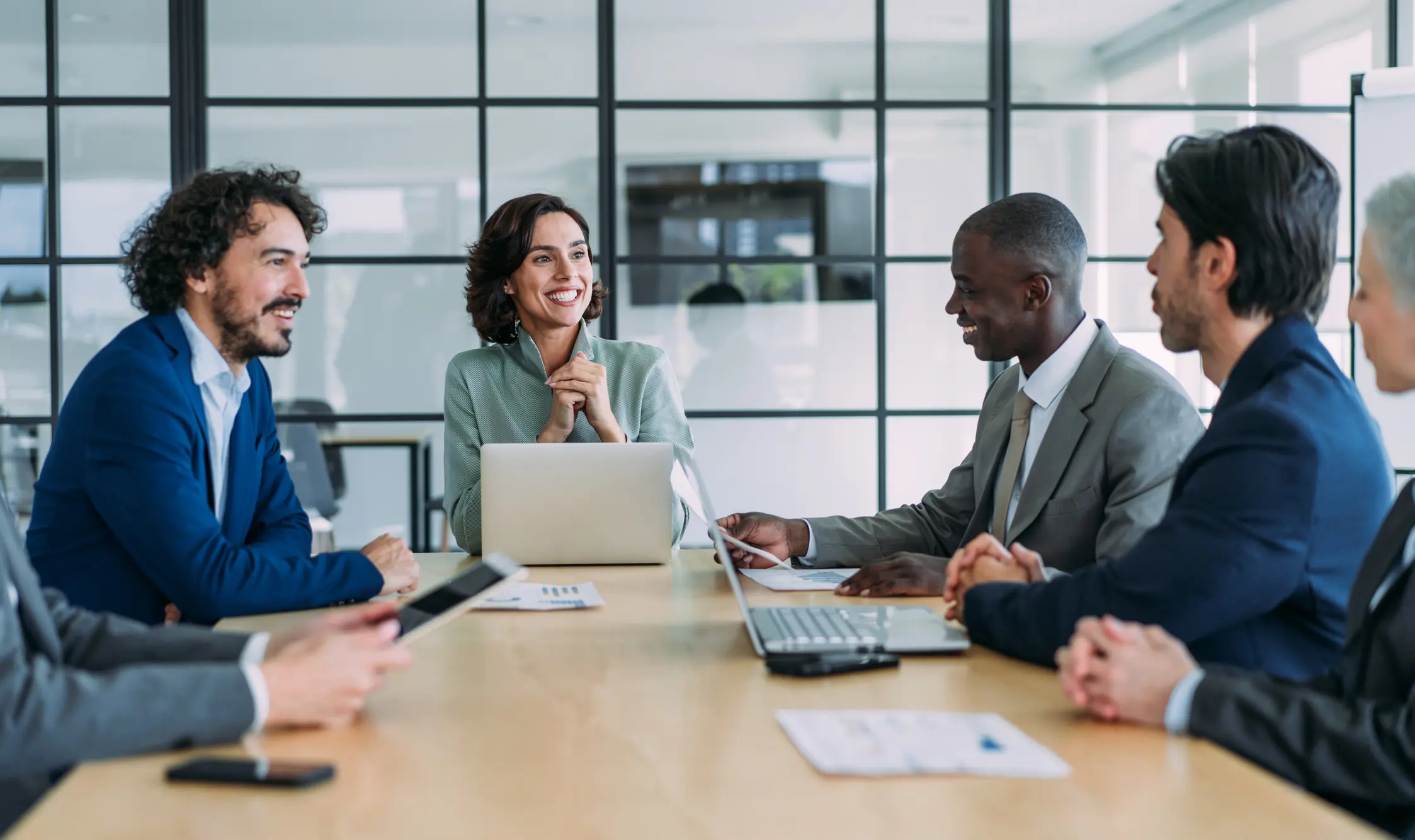 Professionals discussing around conference table