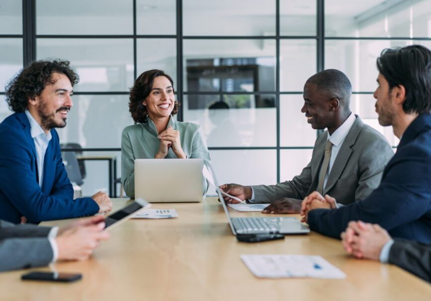 Professionals discussing around conference table